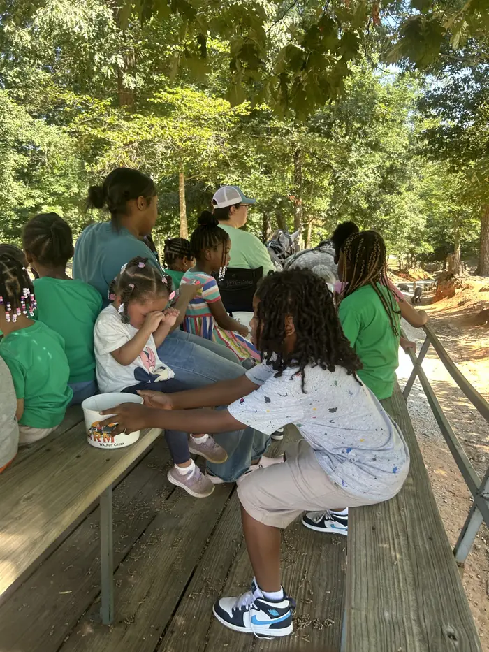 Kingdom Kidz children on a field trip wagon with their teachers